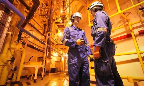 Two workers inside of a nuclear power plant.